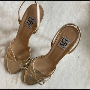 Barney’s New York coop gold high heeled sandals.